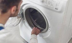 Man checking washing machine