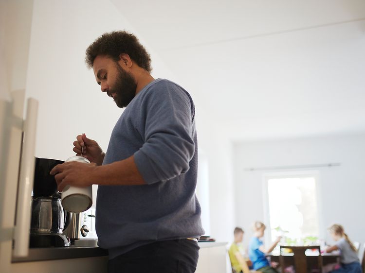 Man looking into coffee jar