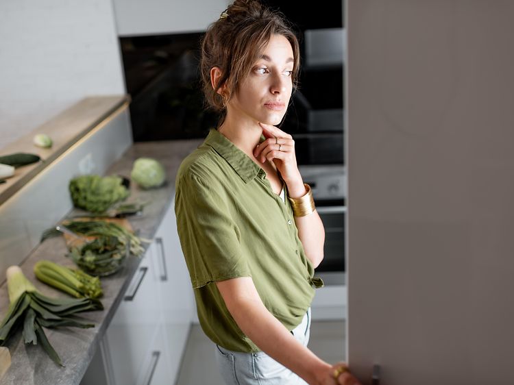 Woman looking into fridge