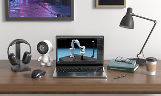 NVIDIA bærbar PC, hodetelefoner, take-away kaffekopp, en lampe, høyttaler, en muse på et skrivebord