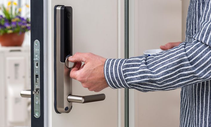 Smart home - smart home security - man's hand on an electronic door lock
