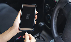 Person placing charger in phone whilst in car