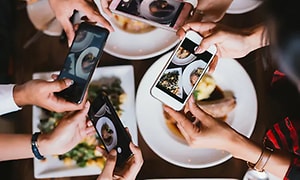photo of many phones taking pictures of food