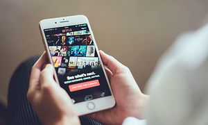 Person streaming Netflix from mobile phone
