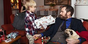 Dad getting christmas gift from his son 