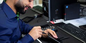 B2B - Sustainability - Elkjøp service employee fixing a smartphone