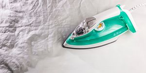 A large piece of white garment being ironed