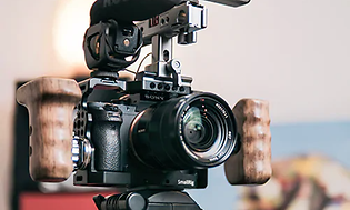 Camera on a tripod with flash and microphone